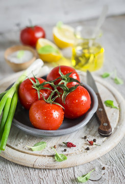 fresh tomatoes on a light wooden background