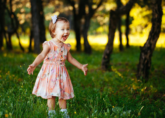 Outdoor portrait of adorable smiling little girl in summer day