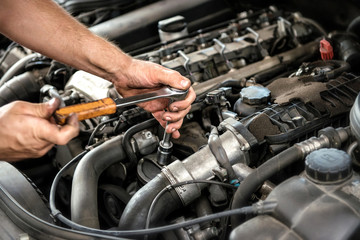 Mechanic using a wrench and socket