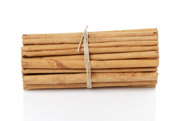 tied true ceylon cinnamon sticks, isolated on white