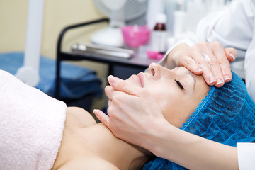 Obraz na płótnie Canvas Facial massage with vitamin cream