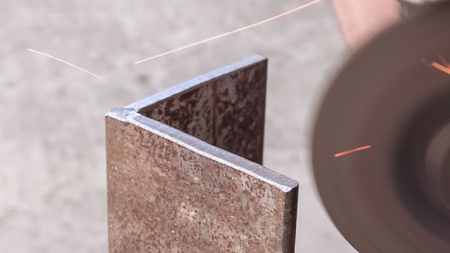 Processing sharp edges on the metallic article by grinding wheel