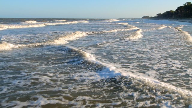 Flying Backwards over waves just above the surface of the water