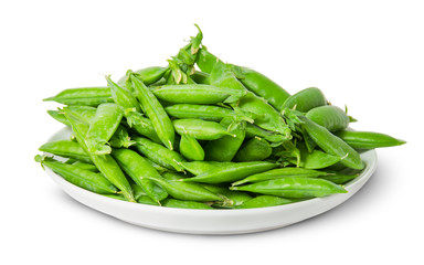 Big pile of green peas in pods on white plate