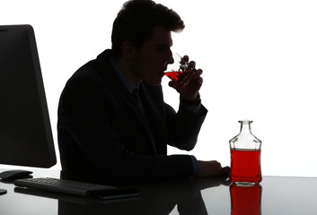 Silhouette of alcoholic drunk man drinking whiskey