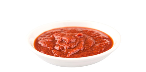 Fresh pureed tomato in white bowl over white background