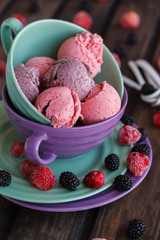 Ice cream BlackBerry and strawberry in the shape of a ball, with fresh berries.selective focus