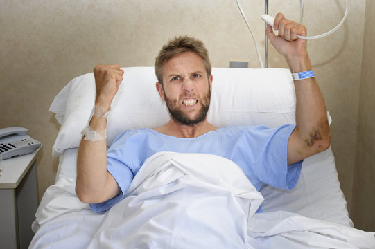 angry patient at hospital room in bed pressing nurse call button upset