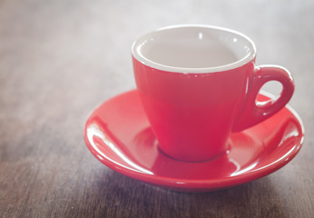 Red coffee cup on wooden table