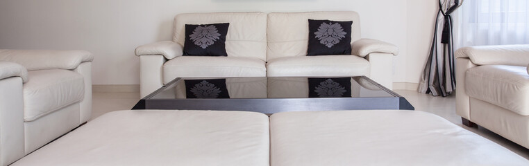 White couch with black cushions
