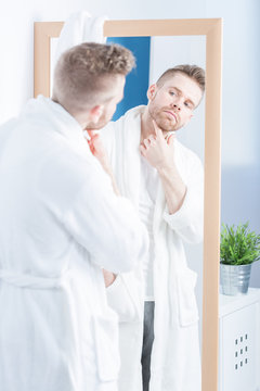 Admiring himself in mirror