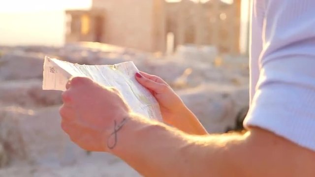 Greek couple look at a tourism map in Greece