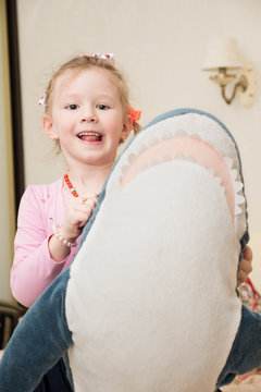 Girl Playing with Plush Toy