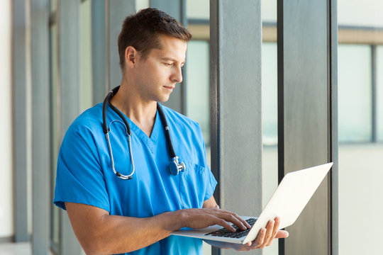 male medical professional using laptop