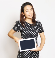Naklejka premium Asian woman using a tablet to work on a white background.