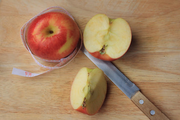 measure tape and apple