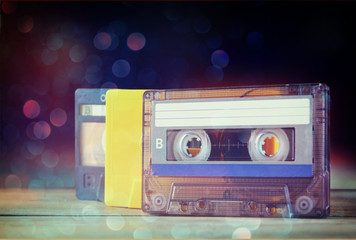 stack Cassette tapes over wooden table. retro filtered