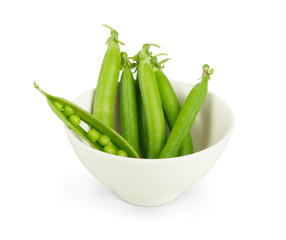 fresh sweet peas on a stack of white saucers
