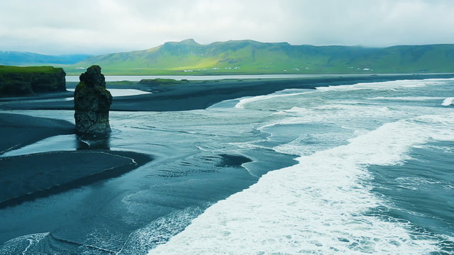 Dyrholaey, a black volcanic beach with cliffs and sea stacks. 