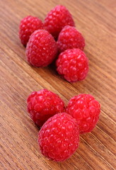 Fresh raspberries on wooden surface, healthy food
