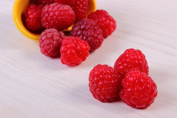 Fresh raspberries on white wooden table, healthy food