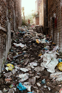 Social Issue, Big garbage heap in between buildings of Indian slums