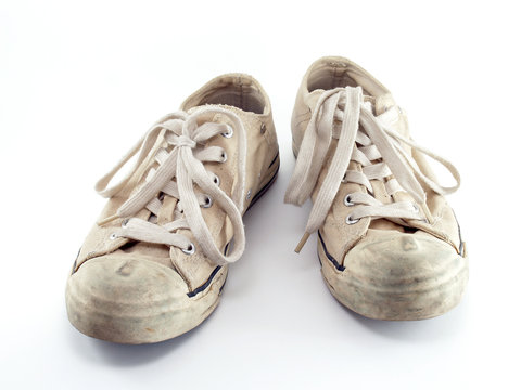 old beige canvas shoes isolated on white, pair of extreme sport sneakers