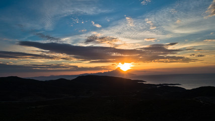 Greek coast of aegean sea at sunrise near holy mountain Athos