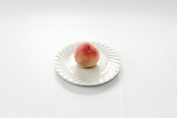 白い皿に乗せた桃