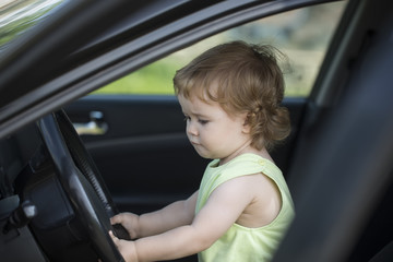 Baby boy driver in car