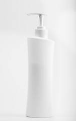 up Plastic bottle of skin care product on white background