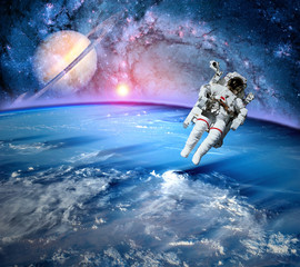 Obraz na płótnie Canvas Astronaut spaceman outer space solar system saturn earth sun. Elements of this image furnished by NASA.