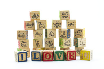 Wooden toy blocks spelling I love you isolated on a white backgr