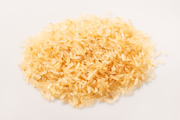 Pile of brown rice seeds isolated on the white background