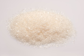 Pile of sugar on white background