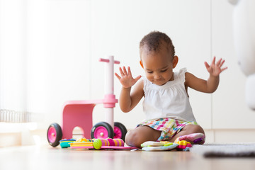 Portrait of little African American little girl sitting on the f