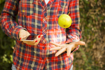 girl with cell phone and green apple