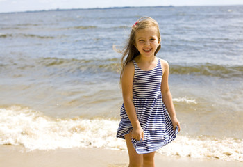 portrait of a happy six-year girl near the sea