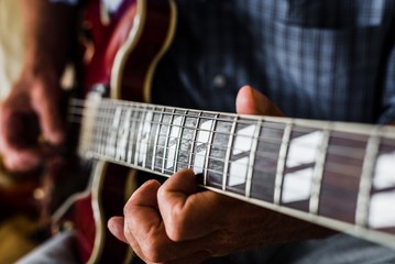 close-up of someone playing the guitar