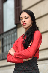 Fototapeta premium Hispanic stewardess in urban background