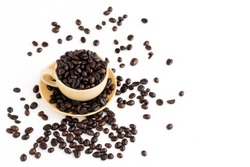Cup full of coffee beans on on white background