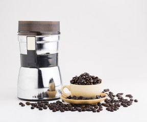 Cup full of coffee beans on on white background