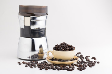 Cup full of coffee beans on on white background