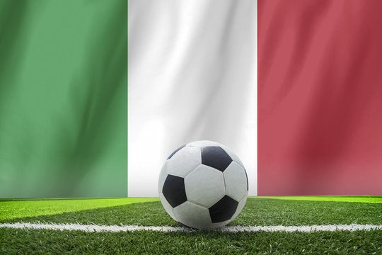 Italy waving flag and soccer ball on grass