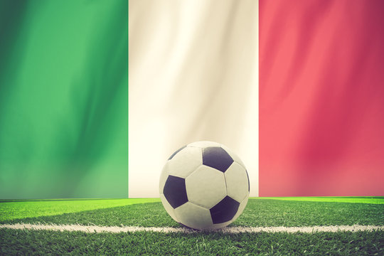 Italy waving flag and soccer ball on grass vintage color