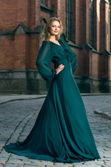 Beautiful luxurious woman in classic green dress