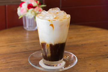 Ice Coffee with milk on the wood desk