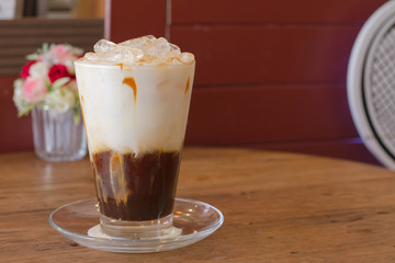 Ice Coffee with milk on the wood desk