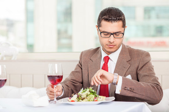 Cheerful young businessman has an appointment in restaurant