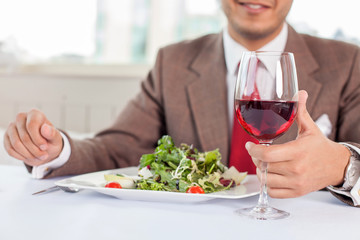 Young successful businessman is resting in restaurant